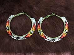 Authentic Beautiful Native American Indian Jewelry Navajo Zuni Hand Beaded 2.25 inch Hoop Earrings Great for a  Gift❤️ Handcrafted by Navajo Artist H. Crosby  Present in virtually every Native American tribe, the feather symbol is universally recognized as a representation of trust, strength, wisdom, freedom, and honor. Incorporated into many sacred pieces of Native American wear, the feather is easily one of the most respected symbols. Native American Hoop Earrings, Southwestern Beaded Round Earrings, Southwestern Style Beaded Round Earrings, Southwestern Round Beaded Earrings, Traditional Festival Beaded Hoop Earrings, Southwestern Style Earrings With Round Beads For Festivals, Southwestern Style Round Bead Earrings For Festivals, Traditional Hoop Beaded Earrings For Festivals, Traditional Hoop Jewelry With Colorful Beads