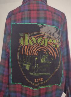 The Doors flannel shirt | one of a kind | ready to ship | hand crafted | upcycled | gift for music lover This is a hand crafted flannel shirt.  Using upcycled materials and breathing new life into them with a completely unique style.  With added color embellishments to create a one of kind garment that is perfect for any music lover Band Tee Flannel, Plaid Graphic Print Flannel Shirt, Vintage Flannel Shirt With Pockets, Flannel Shirts With Rock Bands T- Shirts Sewen On, Streetwear Button-up Flannel Shirt With Pockets, Upcycled Gifts, Upcycled Materials, Gift For Music Lover, Asheville Nc