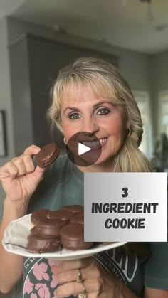 a woman holding a plate with chocolate covered cookies on it and the words 3 ingredient cookie