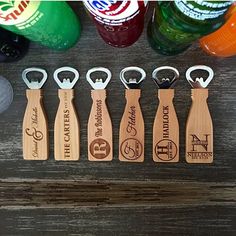 the wooden bottle openers are engraved with their names and date on them, along with several different colored bottles