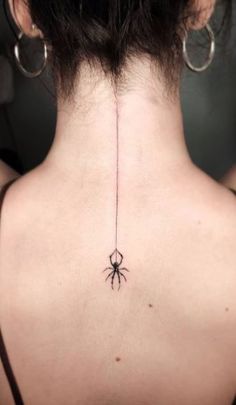 a woman with a spider tattoo on her back