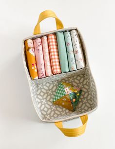 a bag filled with lots of different types of fabric