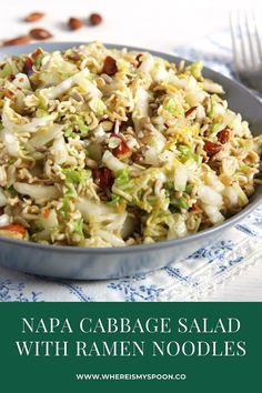 napa cabbage salad with ramen noodles in a blue bowl on a white tablecloth