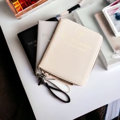 a pair of glasses sitting on top of a white table next to a passport case