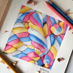 a drawing with colored pencils on top of it next to some crayons