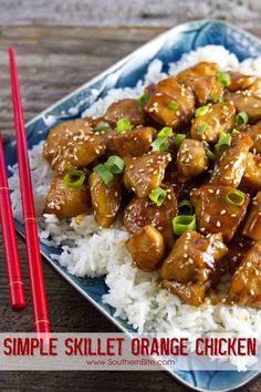 a blue plate topped with rice and orange chicken