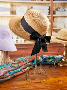 There's no need to choose between feminine flair and good sun sense with this lovely handwoven raffia hat. In addition to its charming grosgrain ribbon and bow it offers UPF 50+ protection and has an elasticized COOLMAX® inner sweatband and a generous wide brim that helps keep your head cool and dry. This hat is also packable, so you can take it anywhere. Handwoven raffia hat with ribbon and bow Paper braid crown Grosgrain ribbon hatband Elasticized COOLMAX inner sweatband UPF 50+ Foldable and packable 3-3/4" brim One size (fits 25" head circumference) Raffia/polyester Spot clean Imported | Women's Raffia Hat With Ribbon and Bow - The Vermont Country Store Braid Crown, Hat With Ribbon, Hat With Bow, Vermont Country Store, Raffia Hat, Paper Hat, Crown Braid, Country Store, Hat Band