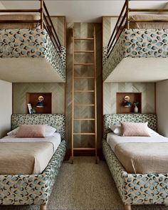 two beds in a room with bunk beds on each side and a ladder between them