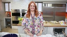 a woman standing in a kitchen next to a counter