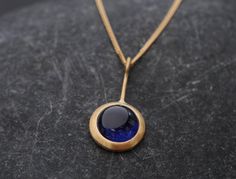 William White | Beautiful Blue Sapphire Necklace in 18k Yellow Gold - Fracture filled Sapphire in Lollipop Pendant Design.  Blue Sapphire Cabochon is 8 mm across Dainty Sapphire Necklace, Gold And Sapphire Necklace, Sapphire Gold Necklace, Heart Shaped Diamond Necklace, William White, Sapphire Cabochon, Blue Sapphire Pendant, Sapphire Necklace Pendants, Blue Sapphire Necklace