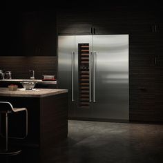 a modern kitchen with stainless steel refrigerator and wine rack