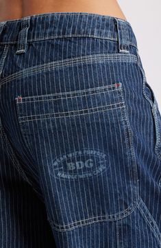 Railroad stripes add to the vintage vibe of nonstretch carpenter jeans featuring a low-rise waist, baggy wide legs and roomy pockets. Exclusive retailer Zip fly with button closure Five-pocket style; side patch pocket 100% cotton Machine wash, line dry Made in Turkey Aesthetic Bottoms, Cute Bottoms, 90s Clothes, Jnco Jeans, Business Casual Shirts, Spring Break Outfit, Earthy Outfits, Clothing Pieces, Bdg Urban Outfitters