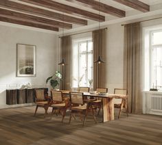 a dining room with wood floors and white walls