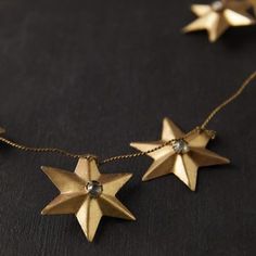 three gold stars are attached to a chain