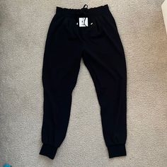 100% Polyester, Nwt Stretchy Waistband With Drawstring, Side Pockets Cuffed Ankles Casual Elastic Black Bottoms, Casual Black Elastic Bottoms, Black Elastic Casual Pants, Casual Black Elastic Pants, Trendy Black Elastic Pants, Black Elastic Pants For Spring, Chic Joggers With Elastic Waistband For Spring, Casual Elastic Bottoms For Workwear, Chic Spring Joggers With Elastic Waistband