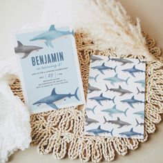 the baby shower is decorated with blue and white shark paper, including a card that says benjamin