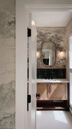 an open door leading to a bathroom with wallpaper