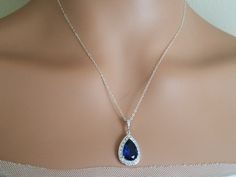 Wedding Sapphire Royal Blue Navy Blue Cubic Zirconia Teardrop Halo Pendant with .925 Sterling Silver Chain Bridal Necklace. Glamorous and elegant, this necklace is perfect for weddings or special occasions such as birthdays, anniversaries, graduations, proms...or whatever you can imagine! CHAIN is 18 inches (45.7 cm) long. PENDANT is about 1.18 inch (3cm) long including bail. Handmade necklace, is made with .925 Sterling Silver 18 inches long cable chain, Rhodium Plated pear shaped Sapphire Navy Blue Teardrop Jewelry For Wedding, Blue Teardrop Wedding Jewelry, Blue Drop Jewelry For Wedding, Sapphire Drop Necklace For Wedding, Blue Teardrop Necklace For Wedding, Formal Blue Teardrop Drop Necklace, Blue Teardrop Drop Necklace For Formal Occasions, Formal Blue Drop Necklace, Blue Bridal Jewelry