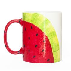 a red and green watermelon painted on a white mug