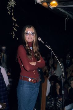 a woman standing in front of a microphone