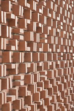 a brick wall made up of small squares and rectangles in various sizes, shapes and colors