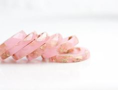 This light pink faceted semitransparent ring made from high quality eco resin is back in stock! The ring contains sparkled metallic yellow gold flakes. This resin ring is perfect for stacking.My resin jewellery is cast in handmade by me silicone molds, hand sanded and hand polished. Minor imperfections may result such as tiny bubbles. My resin rings are comfortable to wear and don't have raw, sharp or unfinished edges. Each ring is unique and slightly different, please keep in mind that yours wo Pink Minimalist, Tiaras Jewellery, Faceted Ring, Pastel Decor, Funky Earrings, Unique Wedding Bands, Resin Ring, Gold Flakes, Pink Ring