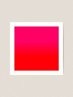 a red and pink square on a white wall