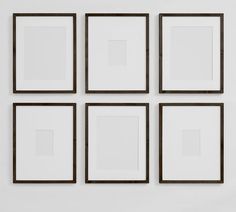 four square frames hanging on the wall with one white and one brown in front of them