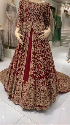 a mannequin dressed in a red and gold gown on display at a store