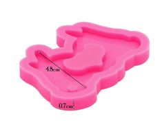 a pink plastic ice tray with the measurements for each piece in front and bottom view