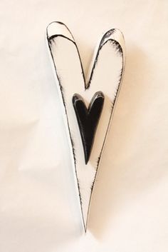 a black and white heart shaped object on a white surface