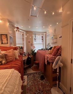 a bedroom with two beds, a rug and lights on the ceiling in it's corner