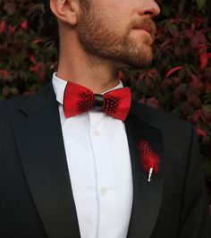 The Jaxon Feather bow tie is a classic red and black tie that will keep it sharp and your look formally fresh. It is a classic, understated, and unique groom's tie. Perfect for weddings and special events. An absolute must-have bow tie to add to your collection. This sleek red tie also comes in children's sizes so your groomsmen and ring bearer bow ties can match! Every Feather Bow Ties Comes with: Beautiful, Hand-Crafted, High Quality Feather Bow Tie, with an adjustable strap that can fit up to Red Ties For Black-tie Events, Dapper Red Suit And Tie Accessories For Formal Events, Dapper Red Suit And Tie Accessories For Formal Occasions, Dapper Bow Tie For Black-tie Events, Dapper Bow Tie For Formal Occasions, Elegant Red Adjustable Bow, Classic Red Bow For Black Tie Events, Classic Red Bow Tie For Formal Occasions, Classic Red Bow Tie For Business