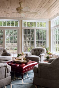 a living room filled with furniture and windows