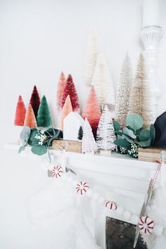 a mantel decorated with christmas trees and candy canes