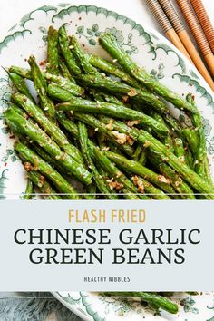 chinese garlic green beans on a plate with chopsticks next to it and the title