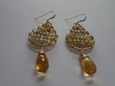 Genuine Grade AAA Golden Micro faceted High Quality Citrine 14K Gold Fill(does not cause allergies, tarnish, flake) Natural Zircon Sparkle Beaded onto Teardrop Frame which is 14K Gold Filled as well.  Length of Earrings from Top of Ear Wire to Bottom of Beads are 60mm or 2 1/2 inches. Citrine Teardrop shape beads are 13mm each. These are Genuine AAA Grade Citrine Drops, Be Careful, there is a lot of people using hydro quartz(glass) passing it off as real gemstones. All metal is 14K GF and All Handmade by me. The tiny Genuine Zircon Beads Sparkle like little Diamonds. Citrine is October Birthstone. Comes in gift box. Ships next Business Day after payment. Gold Briolette Teardrop Handmade Earrings, Handmade Gold Briolette Teardrop Earrings, Elegant Yellow Wire Wrapped Earrings, Handmade Teardrop Citrine Earrings, Handmade Citrine Teardrop Earrings, Earrings Golden, Bead Frame, Citrine Earrings, October Birthstone