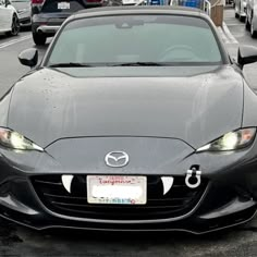 the front end of a black sports car