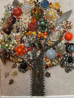 a tree made up of many different types of buttons and beads on a white surface