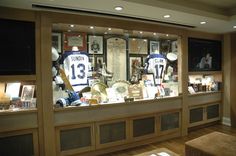 a sports memorabilia display in the corner of a room