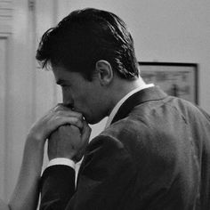 black and white photograph of man in suit looking at computer screen