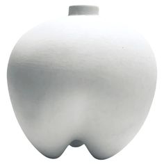 a large white vase is shown against a white background with the shape of an apple