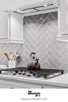 Kitchen Remodel by the Renovation Spot | Grey Herringbone Backsplash for White and Gold Kitchen Remodel | Modern Kitchen Design Modern Grey Kitchen Backsplash, Grey Herringbone Backsplash Kitchen, Kitchen Backsplash Grey And White, Light Gray Herringbone Backsplash, White Cabinets Gray Herringbone Backsplash Black Countertops, White And Grey Kitchen Backsplash Ideas, Kitchen Grey Tiles Wall, Dark Grey Herringbone Backsplash