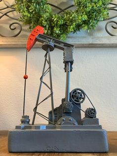 a toy oil pump sitting on top of a wooden table