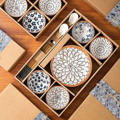 an assortment of blue and white plates in a box