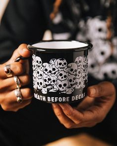 Fill this mug with your favorite cup of coffee and think about all the skulls you're going to crush in your daily activities. Enamel “camping” coffee mug Stainless steel construction w/ enamel coating Holds 12oz Double-sided graphic Black base w/ white pop interior Dishwasher safe Do NOT microwave metal in the microwave! This mug is metal. By Pyknic Cup Print Design Mugs, Coffee Puns, Decaf Coffee, Food Puns, Camping Coffee, Coffee Crafts, Hot Chocolate Mug, Coffee Design, Cute Mugs