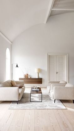 a living room filled with furniture and white walls