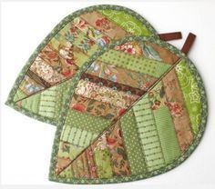 three pieces of green and brown quilted fabric on top of each other with wooden handles