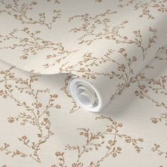 the wallpaper is white and has gold flowers on it, as well as a beige background