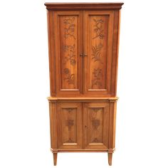 an old wooden armoire with carvings on the front and side doors, is shown against a white background